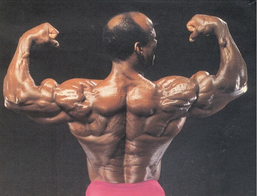 Albert Beckles flexing back double biceps, looking huge and ripped