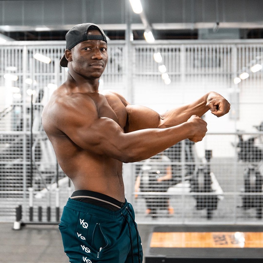 Lubomba Munkuli flexing his muscles in the gym looking fit and lean